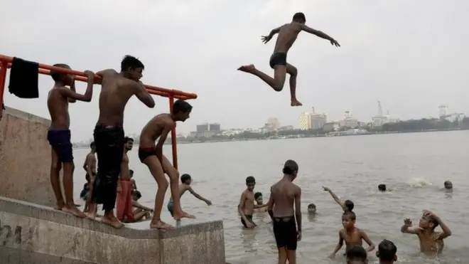 A boy dives into the Ganges River during a hot day in Kolkata, India, 20 April 2022. The summer, or pre-monsoon season, occurs from March to July in eastern India, with the highest daytime temperatures ranging from 35 to 45 degrees Celsius.