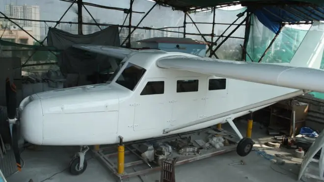 The single engine propeller plane strained to fit into the rooftop