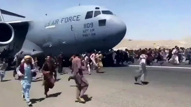 People trying to board plane at Kabul airport