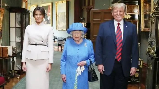 Queen Elizabeth II stands with US President Donald Trump and his wife, Melania, in the Grand Corridor during their visit to Windsor Castle
