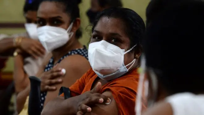 People sit in an observation area after being inoculated with a dose of the Chinese-made Sinopharm Covid-19 coronavirus vaccine as government imposed travel restrictions and weekend lockdown to curb the spread of Covid-19 coronavirus in Colombo on May 16, 2021. (Photo by LAKRUWAN WANNIARACHCHI / AFP) (Photo by LAKRUWAN WANNIARACHCHI/AFP via Getty Images)
