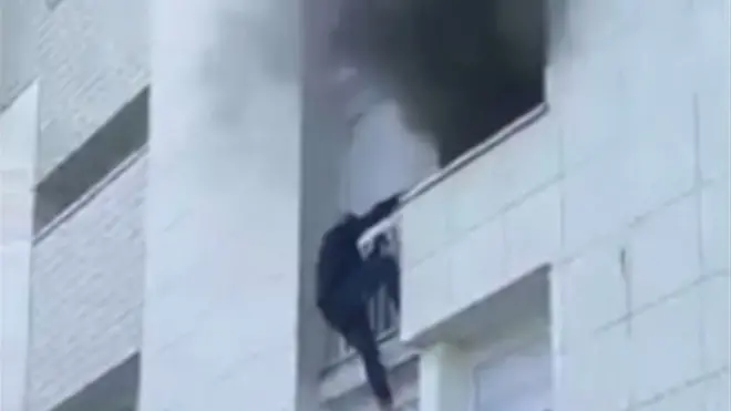 Young man climbs building in Nantes