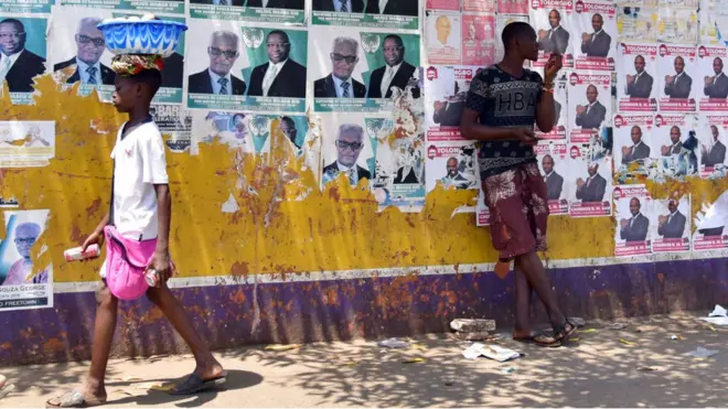 One man rest on top poster wall as e dey wait di result of di presidential election