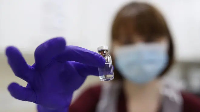 An NHS pharmacy technician at the Royal Free Hospital, London, simulates the preparation of the Pfizer vaccine to support staff training ahead of the rollout