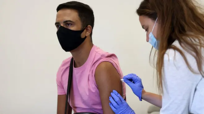 A young man being vaccinated against monkeypox, or mpox