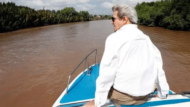 US Secretary of State John Kerry rides a boat in the Mekong Delta