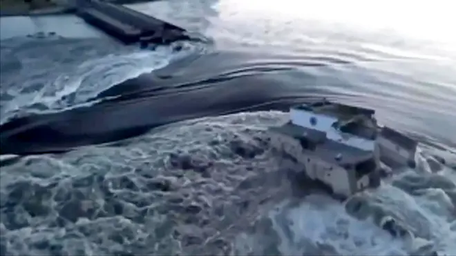 Water gushes through damaged dam