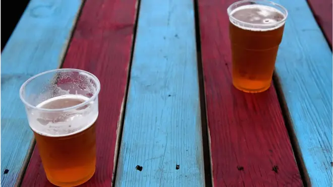 Two glass of beer on top table.