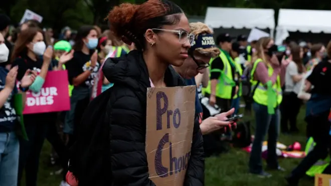 Black woman holds pro-choice sign