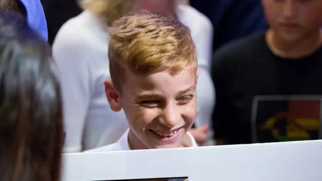 Emad Mishko Tammo, 12, smiles as he is reunited with family in Canada.