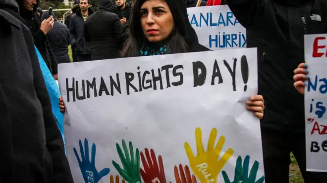Woman holding slogan