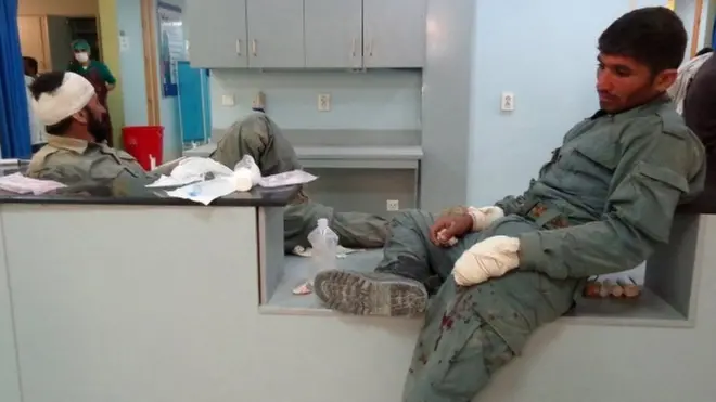 Afghan men injured in the bomb attack on a police training school