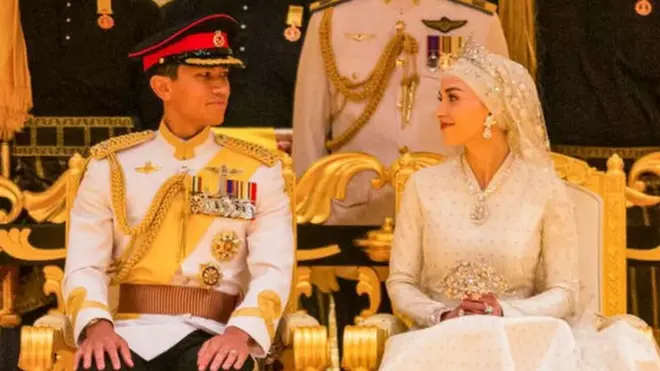 Prince Abdul Mateen and Yang Mulia Anisha Rosnah sit during their wedding reception at Istana Nurul Iman in Brunei's capital Bandar Seri Begawan