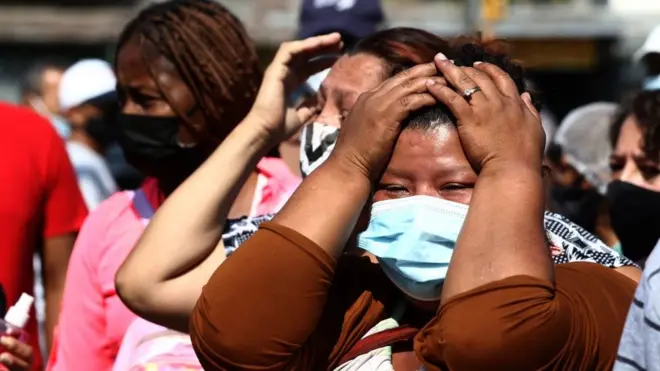 relatives wait outside the prison