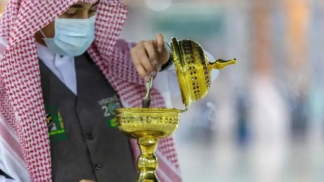 A handout picture provided by the Saudi ministry of media shows a member of the hajj staff burning incense at the Grand Mosque in the holy city of Mecca on 26 July 2020
