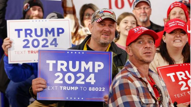 Trump supporters holding signs in Iowa