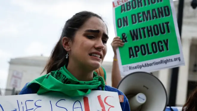Una manifestante pro derecho al aborto en Washington D.C. llora tras conocer la decisión de la Corte Suprema.