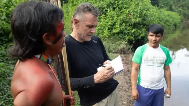 Dom Phillips talks to two indigenous men in Roraima State, Brazil