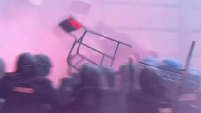 Chair being thrown during clashes between fans and riot police