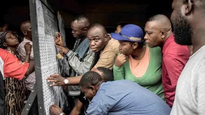 Voters looking at roll