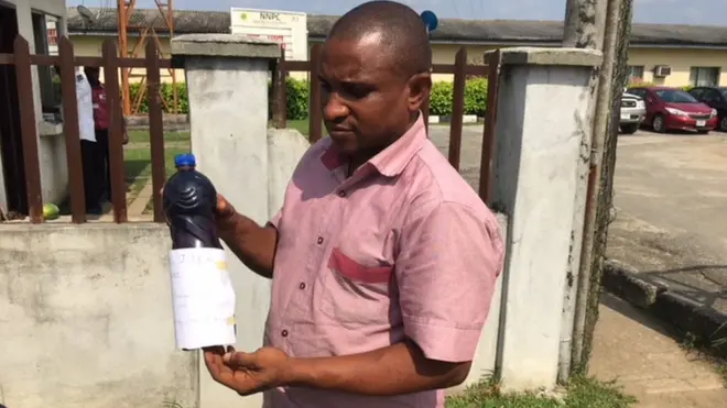 Man carry bottle of wetin fit be kpofire