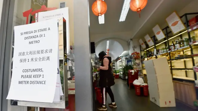 意大利疫情失控开始封国。在米兰的一家商店外，有意大利文，中文和英文三种语言的告示告诫顾客之间必须保持一米的安全距离。