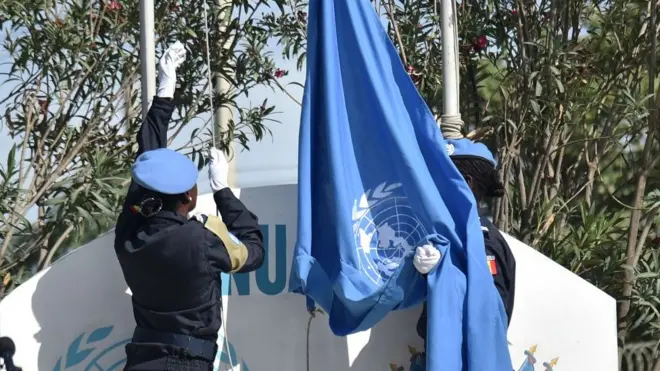 Senegalese police officers of di UN Formed Police Unit as dem dey raise di UN flag for opening ceremony of United Nations Mission for Haiti.