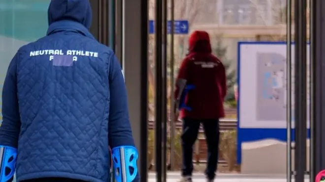 Handout photo dated 03/03/2022 provided by OIS/IOC of Neutral athletes with re-branded clothing arrive at the Paralympic Village. Tape is seen covering the word "Russia" on the back of an athlete"s jacket, ahead of the Beijing 2022 Winter Paralympic Games, Beijing, China. Issue date: Wednesday March 2, 2022.