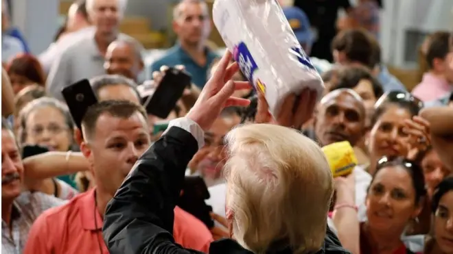 Critics said Mr Trump throwing products out to a crowd resembled a promotional giveaway at a US sports game
