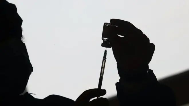 A healthcare worker prepares a dose of the Oxford/AstraZeneca coronavirus disease (COVID-19) vaccine, in Buenos Aires, Argentina June 4, 2021.