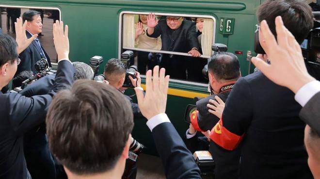 This picture from North Korea's official Korean Central News Agency (KCNA) shows North Korean leader Kim Jong Un waving from his train as it prepares to depart from Beijing railway station.
