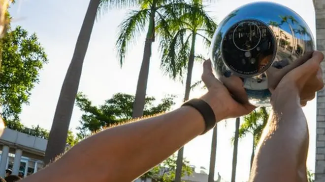 A person using a worldcoin orb