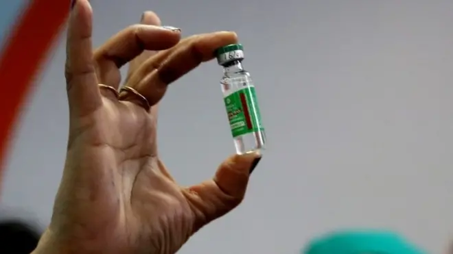 An Indian Health official displays a COVID-19 vaccine manufactured by the Serum Institute of India, at the All India Institute Of Medical Sciences (AIIMS) in Bhopal , India,16 January 2021