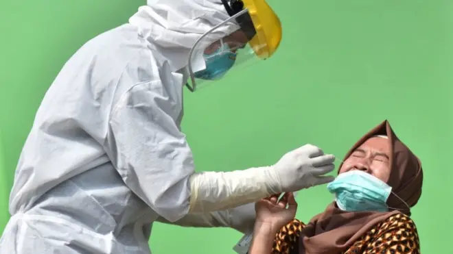 Petugas kesehatan mengambil sampel lendir pada seorang Aparatur Sipil Negara (ASN) saat tes usap (swab test) COVID-19 di Puskesmas Jiwan, Kabupaten Madiun, Jawa Timur, Kamis (07/01)