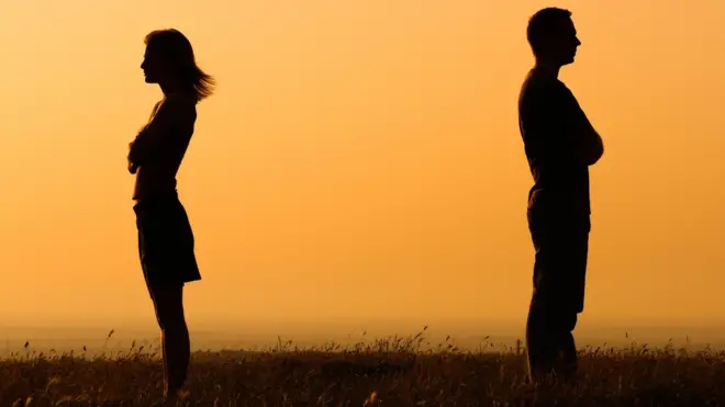 A man and women stand far apart