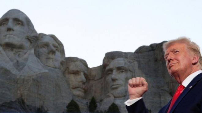 President Trump stands in front of Mount Rushmore