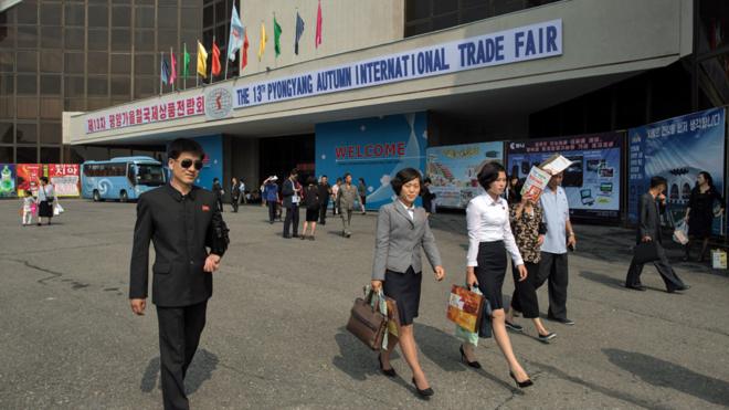North Korean visitors leave the the 13th International Trade Fair in Pyongyang on September 25, 2017