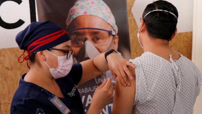 A volunteer in Mexico receives an injection