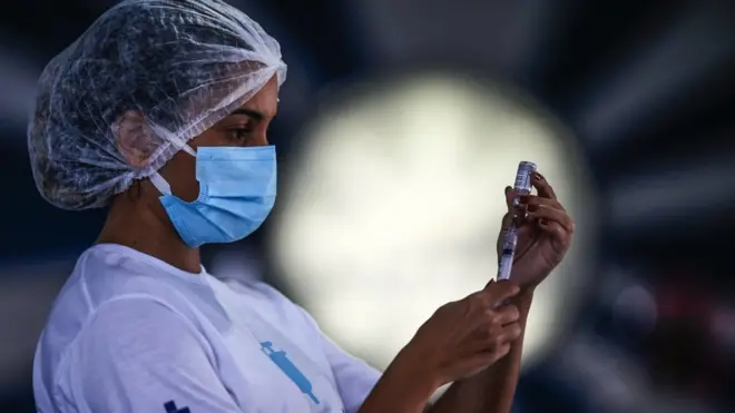 A health worker prepares doses of the AstraZeneca vaccine against Covid-19 (coronavirus) today, in the block of Portela, one of the most traditional carnival groups in Rio de Janeiro, Brazil on 20 April 2021