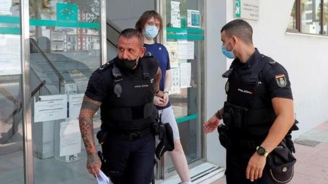 Joseph James O'Connor is lead by Spanish police officers as he leaves a court after being arrested in 2021