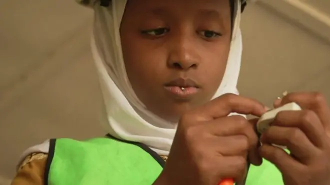 A little girl making an electrical device