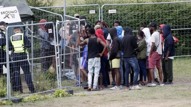 Detained migrants waiting in line at the migrant detention centre in Vydeniai, Lithuania