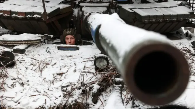 A Ukrainian soldier looks out from a tank as he holds his position near to the town of Bakhmut, Donetsk region, on December 13, 2023