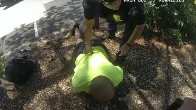 A still showing and early moment of the arrest from the newly released footage