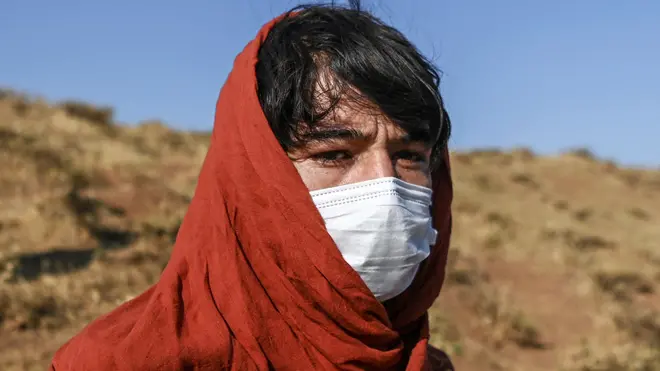 An Afghan man rests while waiting for transport after crossing the Iran-Turkish border - 15 August 2021