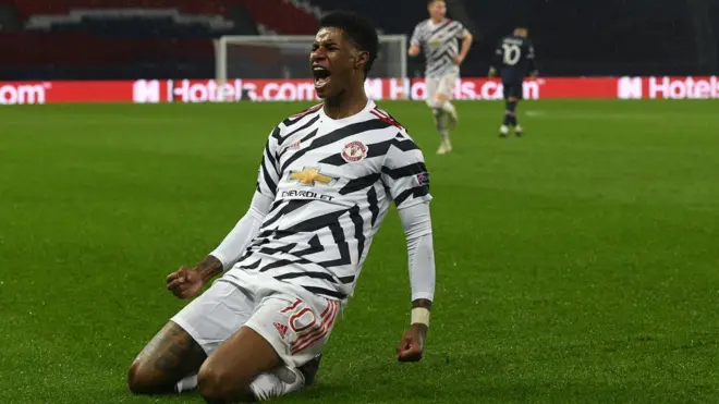 Marcus Rashford celebrates his match-winning goal against PSG in the UEFA Champions League on 21 October