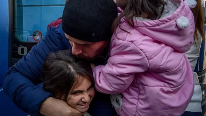 An Armenian man hugs his relatives upon their arrival from Yerevan to the regional capital Stepanakert, on November 22, 2020