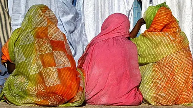 Women sitting down on the ground