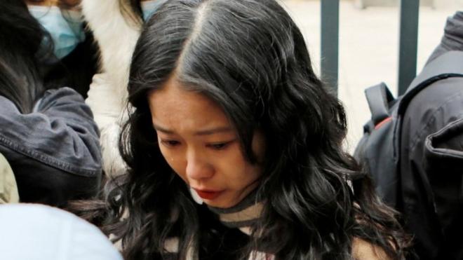 Zhou Xiaoxuan, also known by her online name Xianzi, weeps as she arrives at a court for a sexual harassment case involving a Chinese state TV host, in Beijing, China December 2, 2020.