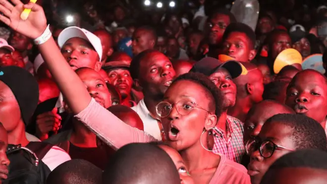 A woman in the audience waving